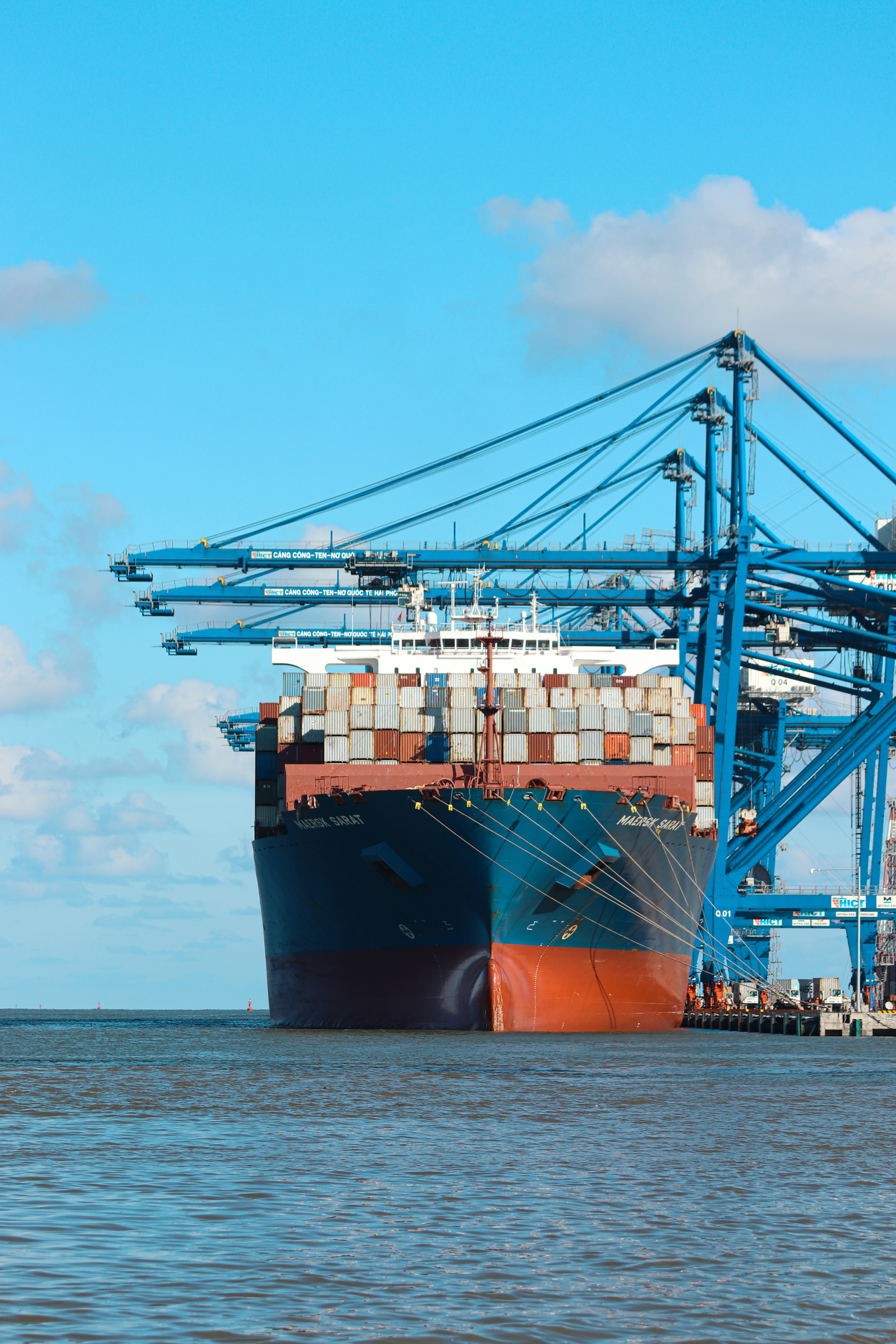 Container ship berthed alongside gantry cranes at a container terminal